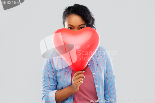 Image of african american woman with heart-shaped balloon