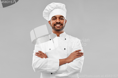 Image of happy male indian chef in toque