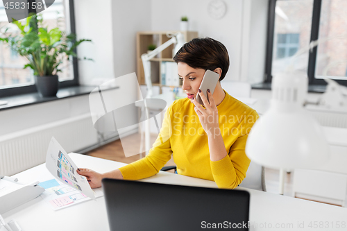 Image of ui designer calling on smartphone at office