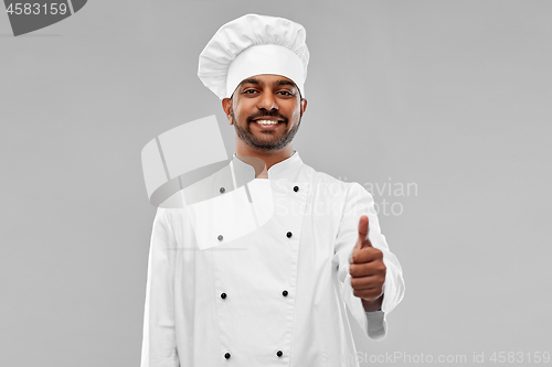 Image of happy male indian chef in toque showing thumbs up