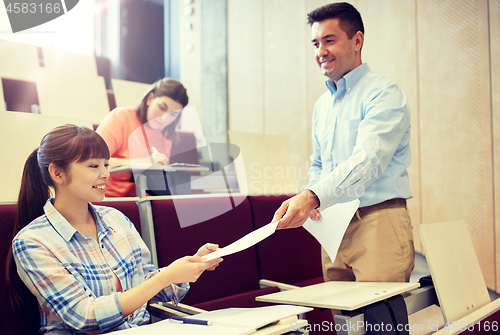 Image of teacher giving tests to students at lecture