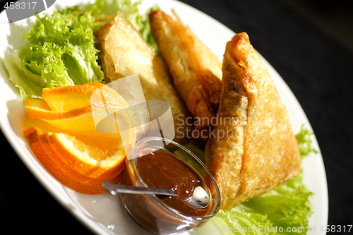 Image of samosa with plum sauce