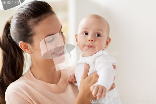 Image of happy mother with little baby boy at home