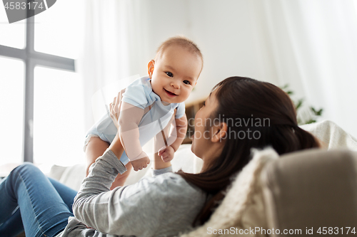 Image of happy mother with little baby son at home