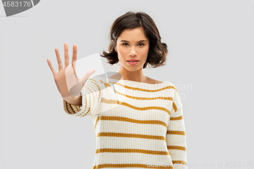 Image of young woman making stopping gesture