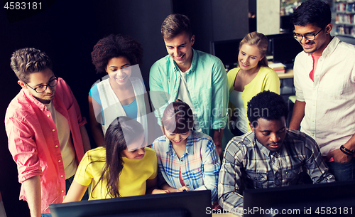 Image of international students with computers at library