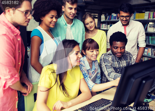 Image of international students with computers at library