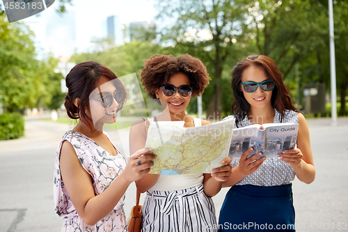 Image of happy women with city guide and map in summer