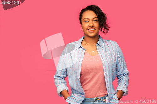 Image of happy african american woman over pink background