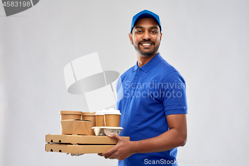 Image of happy indian delivery man with food and drinks