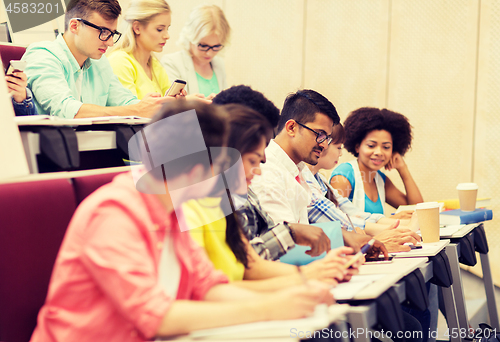 Image of group of students with coffee writing on lecture