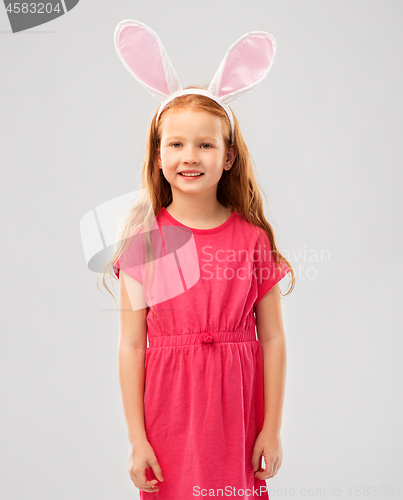 Image of happy red haired girl wearing easter bunny ears