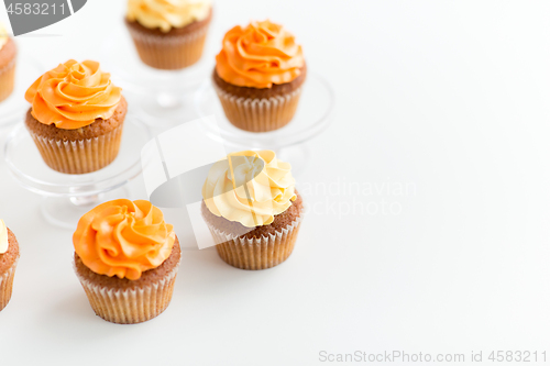 Image of cupcakes with frosting on confectionery stands