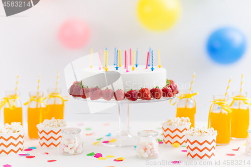 Image of birthday cake, juice, popcorn and marshmallow