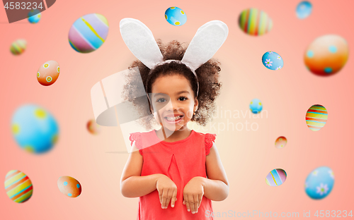 Image of happy little girl wearing easter bunny ears