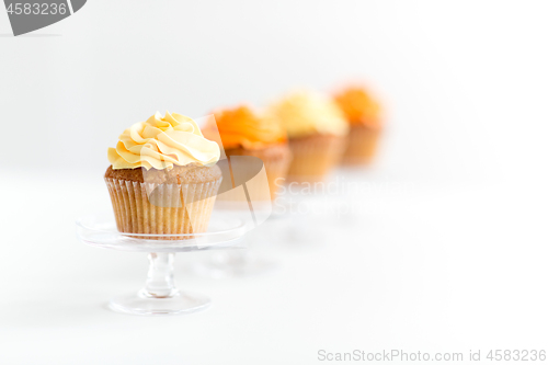 Image of cupcakes with frosting on confectionery stands