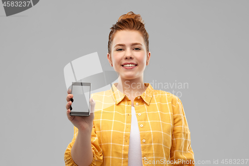 Image of smiling red haired teenage girl showing smartphone