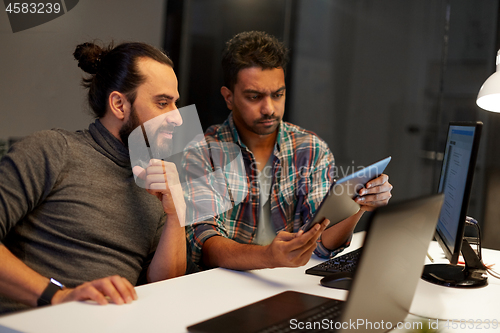 Image of creative team with tablet pc working at office