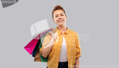 Image of smiling red haired teenage girl with shopping bags