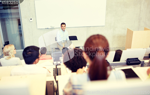 Image of group of students and teacher at lecture