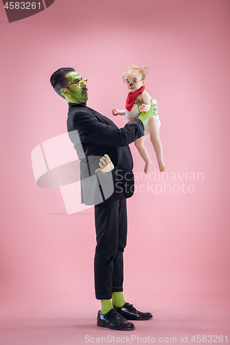 Image of Halloween Family. Happy Father and Children Girl in Halloween Costume and Makeup