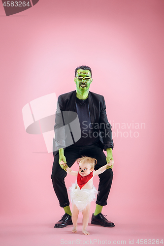 Image of Halloween Family. Happy Father and Children Girl in Halloween Costume and Makeup