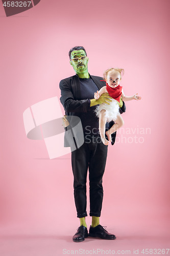 Image of Halloween Family. Happy Father and Children Girl in Halloween Costume and Makeup