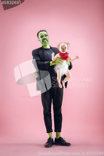 Image of Halloween Family. Happy Father and Children Girl in Halloween Costume and Makeup