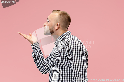 Image of Portrait of attractive man with kiss isolated over pink background