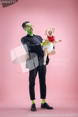 Image of Halloween Family. Happy Father and Children Girl in Halloween Costume and Makeup