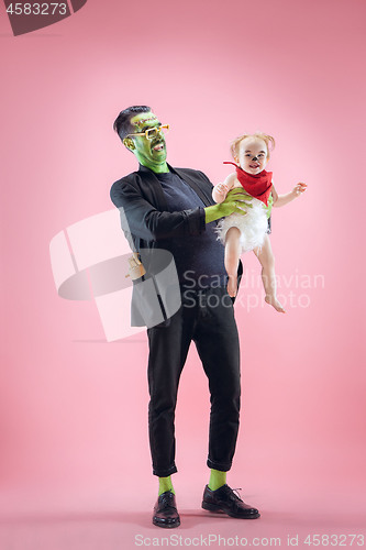 Image of Halloween Family. Happy Father and Children Girl in Halloween Costume and Makeup