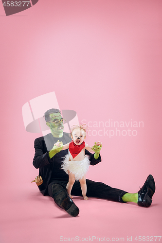 Image of Halloween Family. Happy Father and Children Girl in Halloween Costume and Makeup