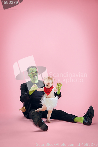 Image of Halloween Family. Happy Father and Children Girl in Halloween Costume and Makeup