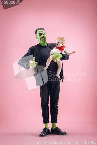 Image of Halloween Family. Happy Father and Children Girl in Halloween Costume and Makeup