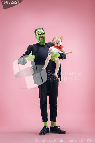 Image of Halloween Family. Happy Father and Children Girl in Halloween Costume and Makeup