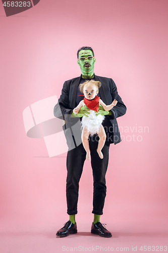 Image of Halloween Family. Happy Father and Children Girl in Halloween Costume and Makeup