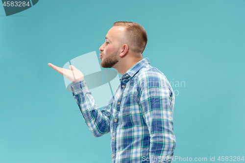 Image of Portrait of attractive man with kiss isolated over blue background