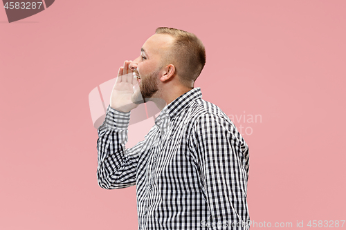 Image of Isolated on pink young casual man shouting at studio