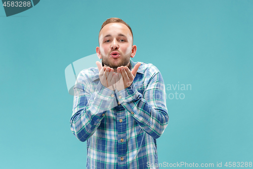 Image of Portrait of attractive man with kiss isolated over blue background