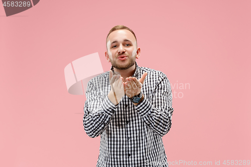 Image of Portrait of attractive man with kiss isolated over pink background