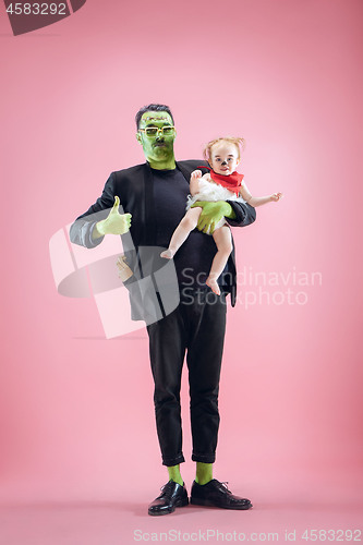 Image of Halloween Family. Happy Father and Children Girl in Halloween Costume and Makeup