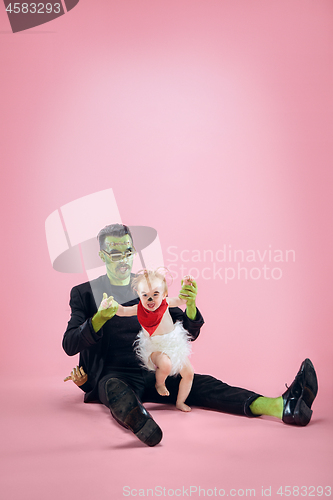 Image of Halloween Family. Happy Father and Children Girl in Halloween Costume and Makeup