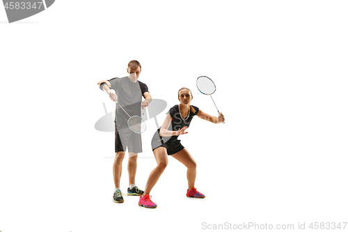 Image of couple playing with badminton rackets isolated on white