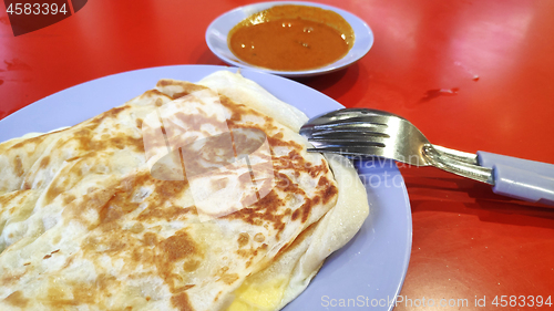 Image of Roti canai with curry sauce 