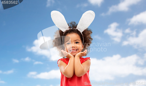 Image of happy little girl wearing easter bunny ears posing