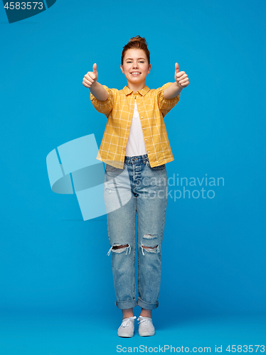 Image of happy red haired teenage girl showing thumbs up