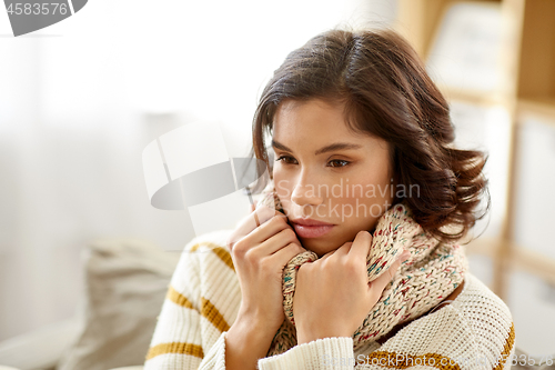 Image of sad sick woman in scarf at home