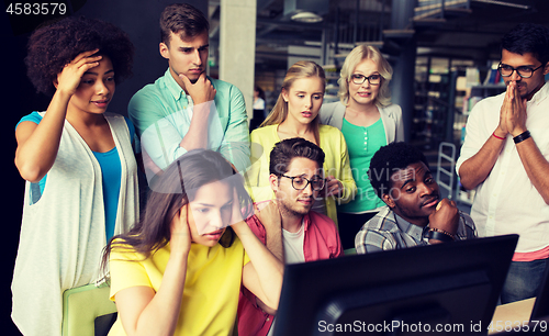 Image of international students with computers at library