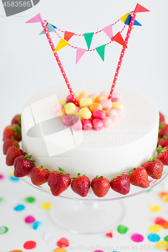 Image of close up of birthday cake with garland on stand