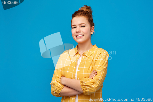 Image of smiling red haired teenage girl with crossed arms